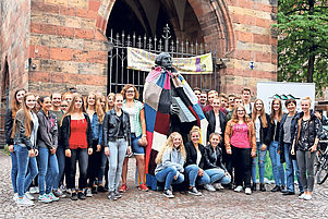 Stolz auf die soeben beendete Gemeinschaftsarbeit: Die Schüler mit ihrem Umhang für das Luther-Standbild in Landau. Foto: Iversen
